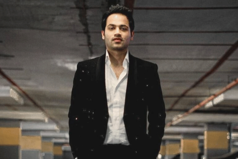 Raj Shamani in a black suit representing confidence and success