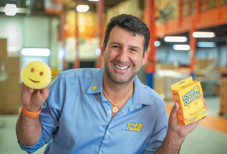 Man holding Scrub Daddy sponge and box